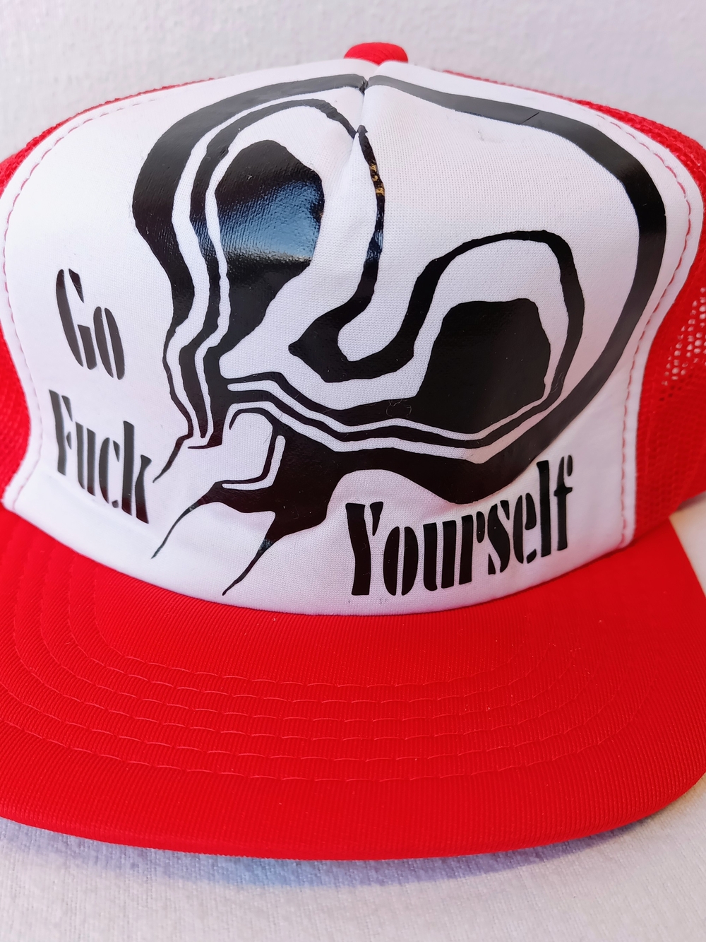 Red and White Graphic Trucker Hat with Bold Black Print